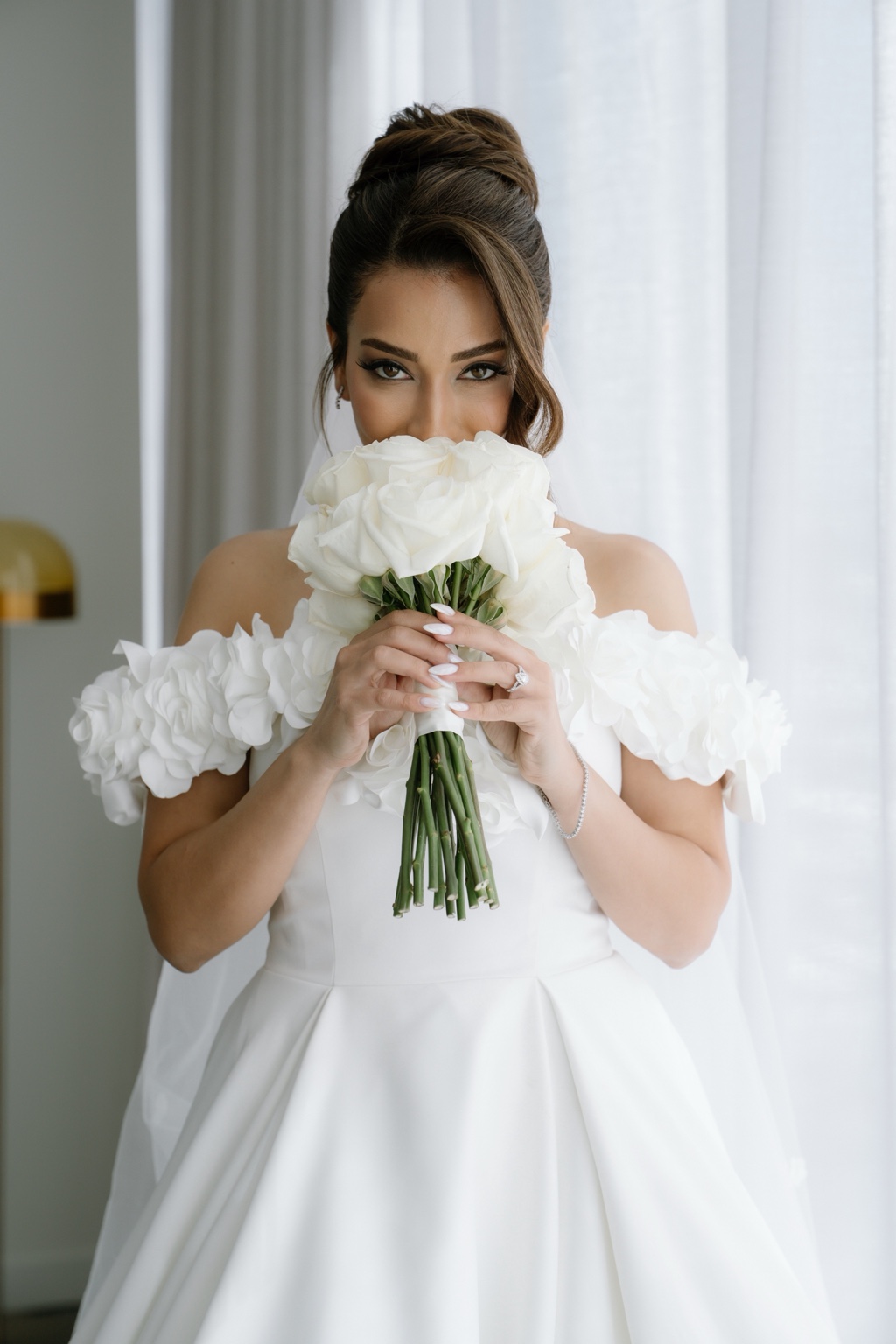 Bridal eye makeup above a white rose bouquet